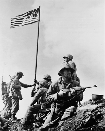 The first flag raising on Mount Suribachi, February 23, 1945. Taken by Staff Sgt. Lou.